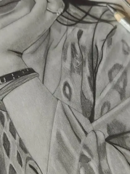 A close-up work-in-progress shot focusing on the intricate patterns of the clothing.