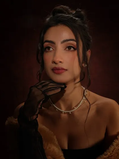 Channeling old-world glamour for this photoshoot. The makeup features a classic winged liner, a deep berry lip, and softly sculpted cheeks, creating a vintage-inspired look that is both elegant and modern.