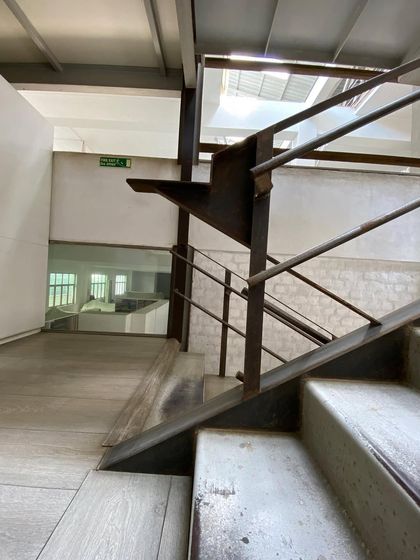 A detail of the steel balustrade and concrete steps at Zanav Home, showcasing the honest joinery and material expression.