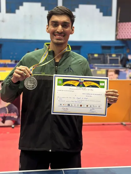 Deepit Patil proudly displays his silver and gold medals won at the All India Public Sector Table Tennis Tournament, where he represented the Airport Authority of India team.
