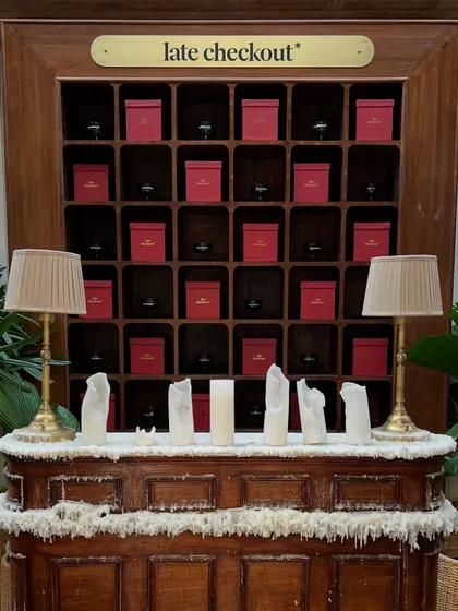 We even integrate the venue's existing features, like this 'late checkout' shelf, into the decor with themed elements like faux snow and candles.