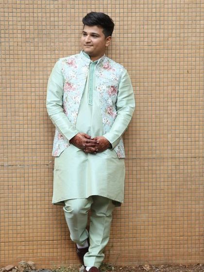 This client is wearing a pista green kurta set with a floral open jacket. It's a comfortable yet stylish choice for a Mehendi or other pre-wedding celebration.