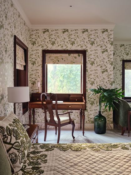 A vintage writing desk sits by the window in the master bedroom, looking out onto the garden. We preserved the original window frames, layering new life onto the room's history without erasing it.