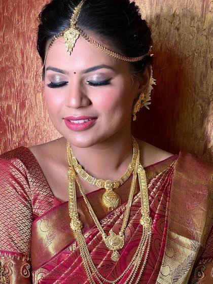 That golden hour glow on a South Indian bride. This close-up shows the shimmering eye makeup and flawless skin.