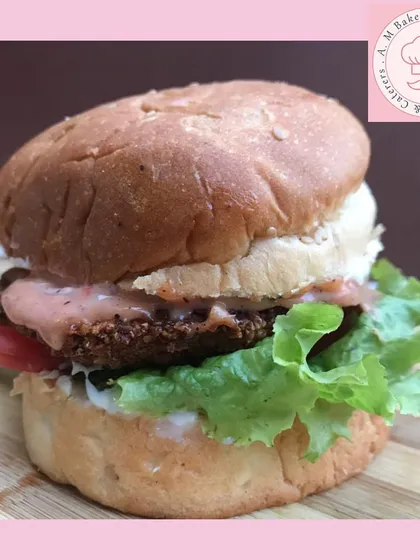 This is my homemade chicken burger. I use a juicy, seasoned chicken patty, fresh lettuce, and my special sauce, all served in a soft bun that I bake myself. It’s a complete, satisfying meal.