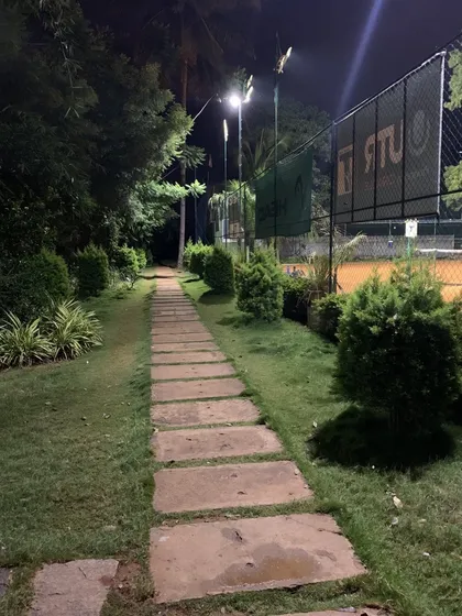Your game starts here. Even the walk to the courts is part of the experience, with landscaped paths surrounded by greenery that set us apart from the usual city tennis scene.