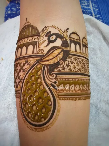 This is a full arm band design featuring a royal peacock against an architectural backdrop. The combination of fine lines and bold shading makes the design stand out.