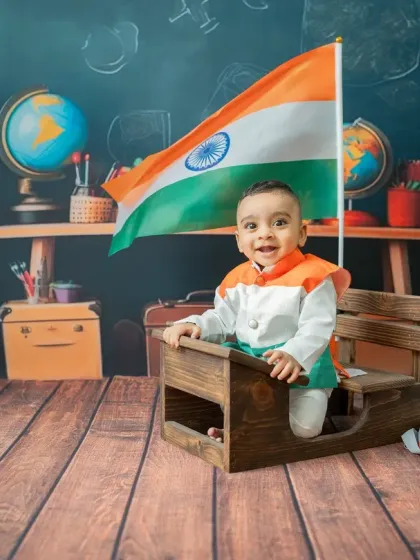 A proud little patriot celebrating Republic Day. This theme features a classroom setting, a miniature desk, and the Indian flag, creating a fun and meaningful photo.