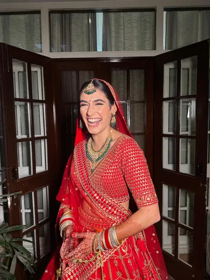 A candid moment of pure happiness. This laughing shot captures the essence of a wedding day. The makeup is designed to look fresh and beautiful from every angle, in every light.