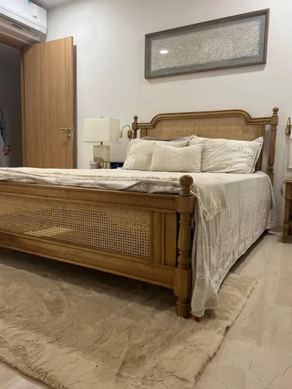 Another angle of the custom oak and cane bed in the client's bedroom.