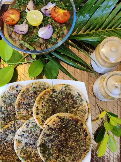 A classic North Indian comfort meal of Amritsari Kulcha served with a hearty bowl of homemade Chana Masala, garnished with fresh herbs and onion.