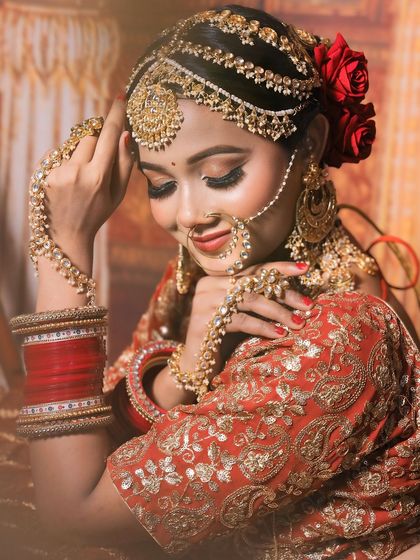 A beautiful, soft-focus shot of a bride in her complete golden jewellery set, creating a dreamy and romantic feel.
