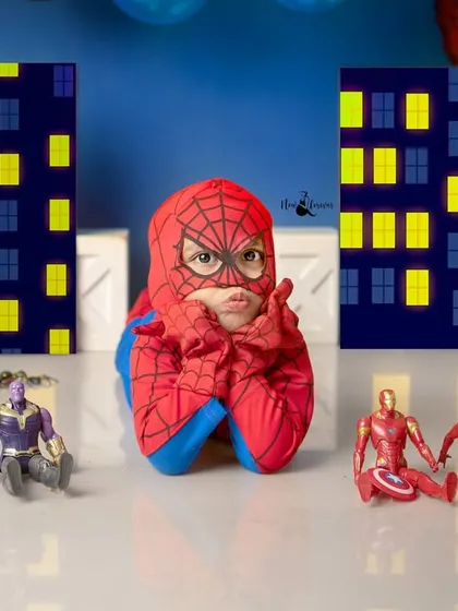A classic Spidey pose! This little hero shows off his thoughtful side while surrounded by his team of superheroes.