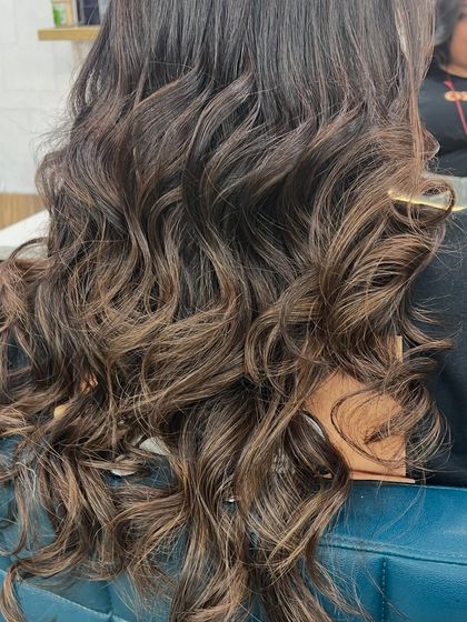 A closer look at the rich, chocolatey curls. This style is perfect for adding glamour and showing off the subtle variations in the hair color.