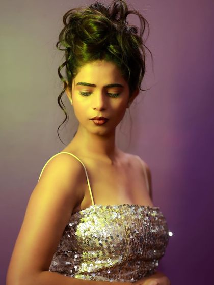 A beautiful and introspective portrait. The creative lighting and her downward gaze create a moody and artistic feel.