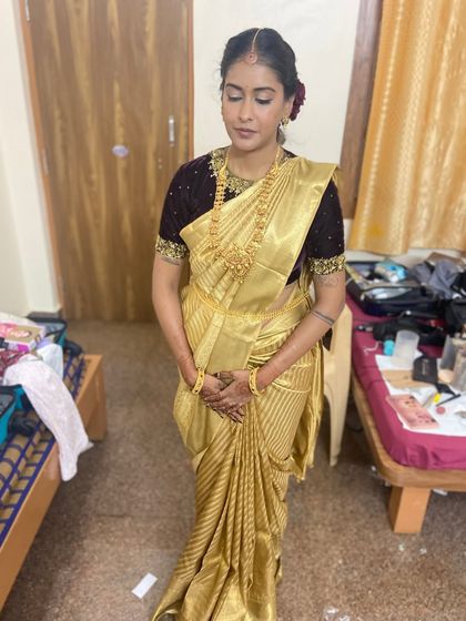 The client looking serene in her golden saree.