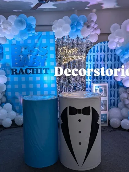 A full Boss Baby themed birthday setup perfect for your little leader. This decoration transforms the room with coordinated blue and white balloon arches, character standees, and themed pedestals ready for the cake cutting ceremony.