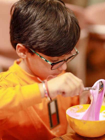 A young guest gets creative with a slime-making activity at a Blippi-themed party. We offer hands-on activities that fit any theme.