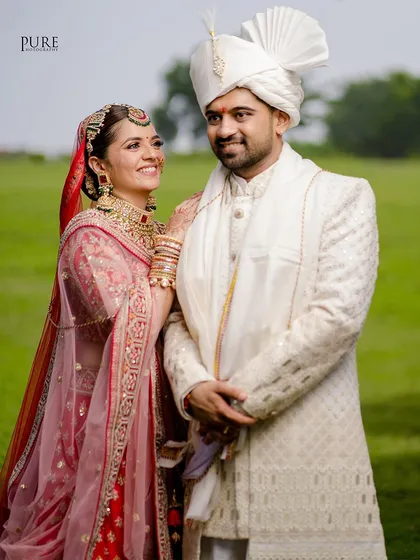 A classic wedding portrait with a beautiful, natural background. The couple's happy expressions make this a timeless memory.
