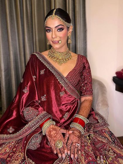 A closer look at this gorgeous bride. The makeup is crafted to enhance her features, with a focus on creating a look that is both regal and timeless.