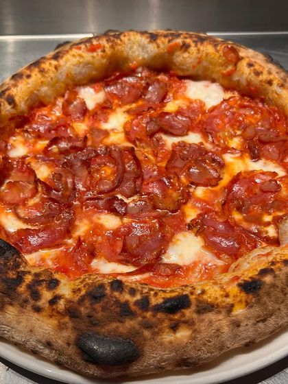 Testing out a spicy sausage pizza during our dough trials. We have to make sure the crust holds up to all kinds of toppings.