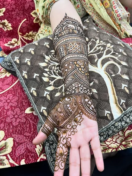 A close-up of the intricate arm work for bride Ayesha, showcasing the detailed patterns.