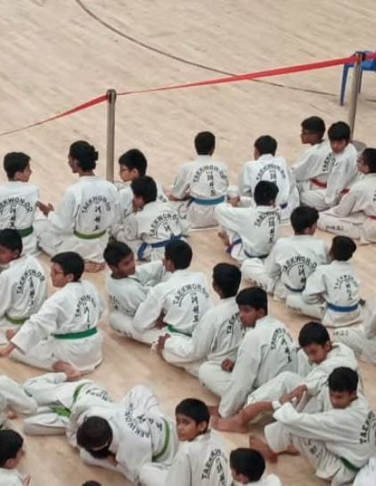 An overhead shot of students seated and ready for instruction at a competition.