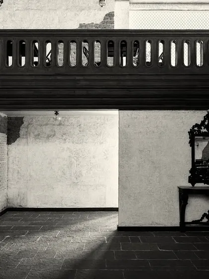 An empty corner of the room, where light and shadow play across the stone floor. The design uses negative space to create a sense of calm.