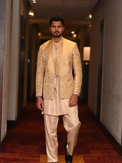 Walking down a hotel corridor in a full ethnic ensemble, creating a sense of movement and narrative for this "Desi vibes" look.