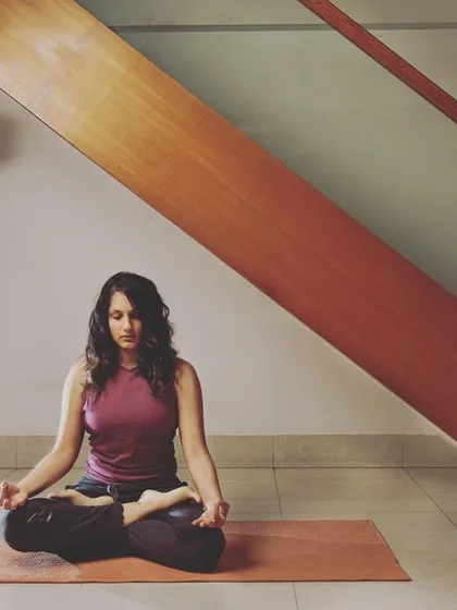 A calm moment of seated meditation in Padmasana, or Lotus Pose. This is the foundation for many mindfulness practices, including chanting. Understanding the components of a chant like OM, from its individual sounds to the silence that follows, transforms it from simple repetition into a profound meditative experience.