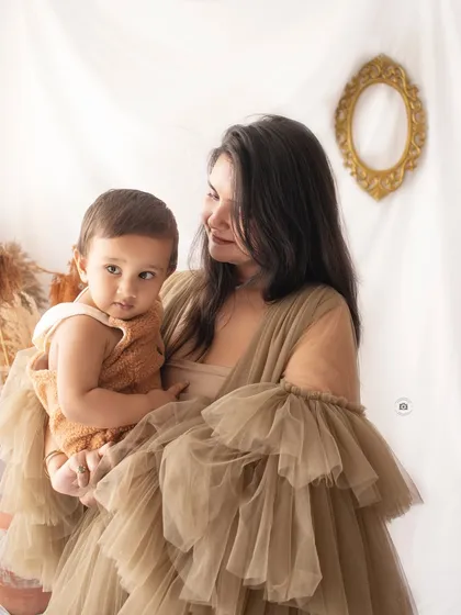 A loving portrait of a mother and her child. The soft textures and neutral colors of the boho set add to the warmth of this beautiful moment.