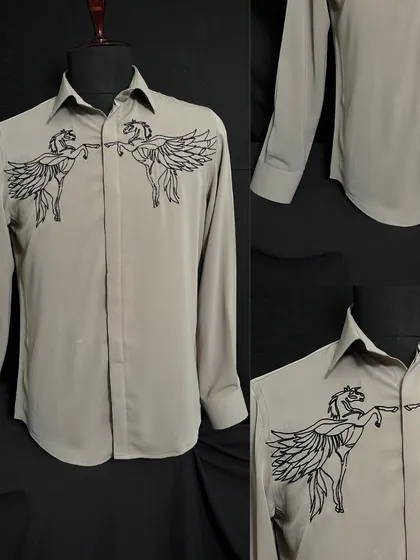 A unique grey shirt featuring two embroidered winged horses meeting at the center. This design is for the man who appreciates bold, artistic, and meaningful fashion.