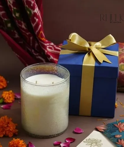 This luxury jar candle is stunning with its navy box and golden ribbon. The textured glass creates a beautiful effect when the candle is lit.