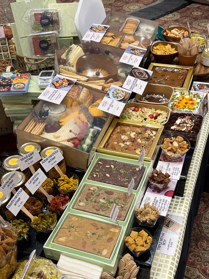 A closer look at the product display at the FICCI FLO exhibition. You can see the variety of mithai, pickles, grazing boxes, and salads that were on offer for tasting and purchase.