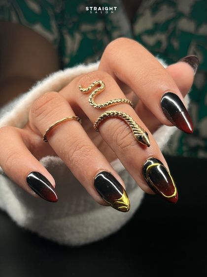 A close-up of the black and red ombre set, highlighting the sculpted gold accent. The dark, moody gradient is perfect for making a bold statement.