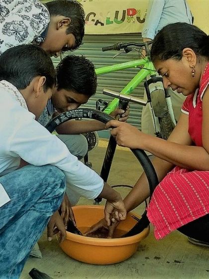 A group of kids learning how to properly clean bicycle parts. Regular maintenance is a key part of our curriculum, teaching children that taking care of their belongings is just as important as fixing them.