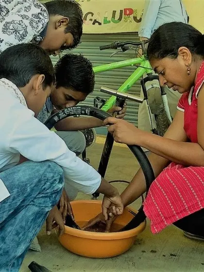 A group of kids learning how to properly clean bicycle parts. Regular maintenance is a key part of our curriculum, teaching children that taking care of their belongings is just as important as fixing them.