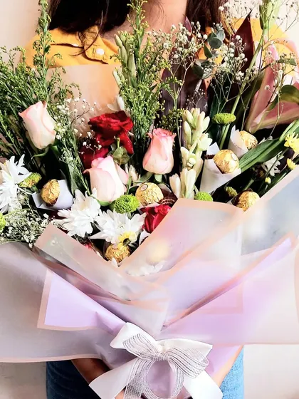 Sometimes, the best way to send love is with flowers and chocolates. This stunning bouquet combines fresh, vibrant flowers with delicious Ferrero Rocher chocolates.
