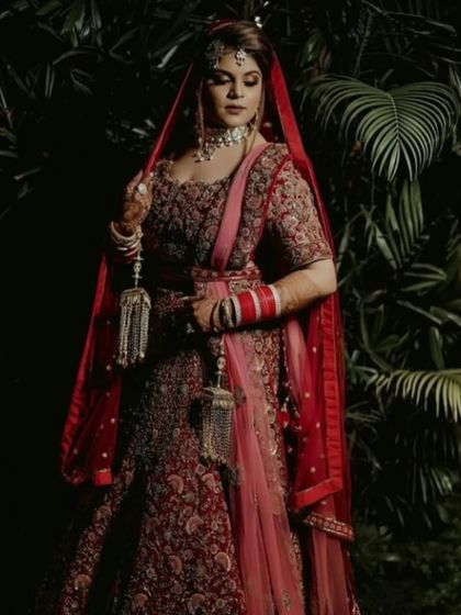 A full-length portrait that captures the grandeur of the bridal attire. The makeup is balanced to complement the entire look, creating a vision of elegance.