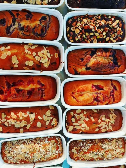 A tray of assorted tea cakes, including blueberry, strawberry, and almond variations. These are perfect for an afternoon snack or to sell in a cafe.