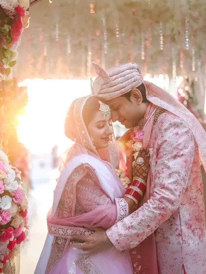 An intimate portrait of a bride and groom, their faces close together, bathed in the soft, warm glow of the golden hour. This photo highlights my focus on capturing tender, candid moments that feel both timeless and deeply personal.