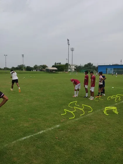 Players taking a breather during a tough fitness day. We push our athletes to their limits to build the stamina required for 90 minutes of high-intensity football.