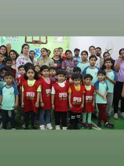 A group of our young athletes and their parents posing for a photo after the competition.