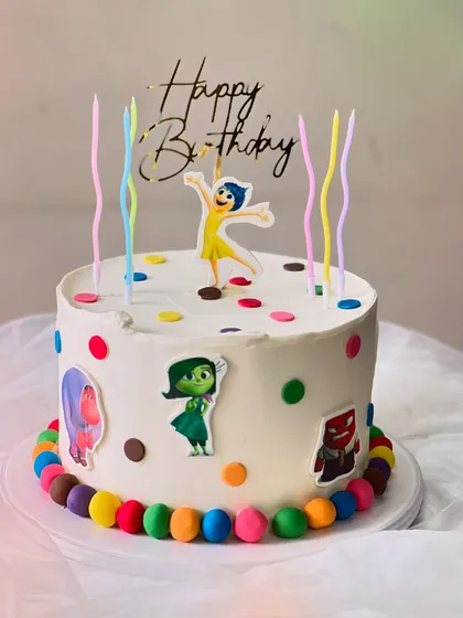 An "Inside Out" themed birthday cake made with my Belgian Chocolate flavor. It's decorated with colorful polka dots, character cutouts, and rainbow candles.