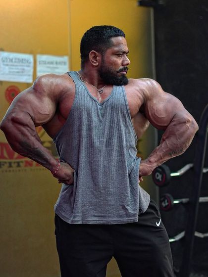 Lat spread pose. This is crucial for showing back width on stage.