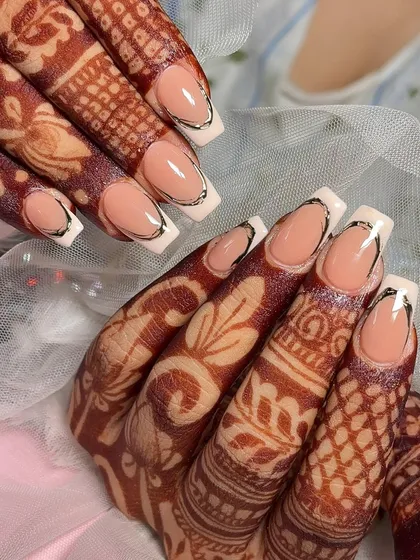 A close-up of this modern squared French manicure with a silver chrome outline.