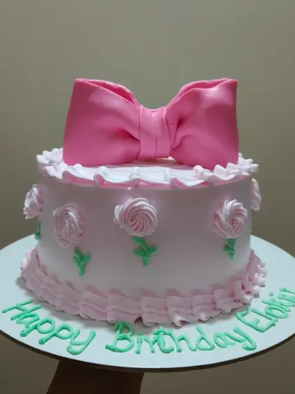 A pretty pink cake with a large, handcrafted fondant bow on top. This is a very cute and popular design for birthdays.