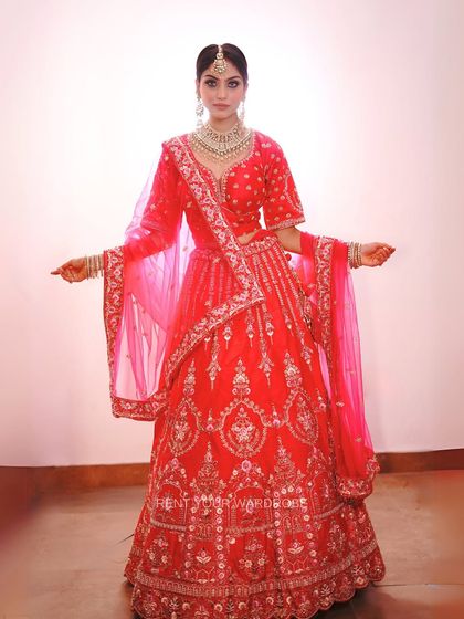 A full-length view of the red and pink lehenga, perfect for a bride's sister or a wedding guest.