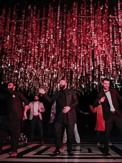 A group of friends performing a choreographed dance at the Sangeet, a classic and heartwarming part of the celebration.