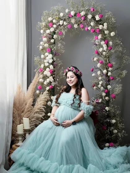 The radiant glow of motherhood deserves to be celebrated. In my Noida studio, I create dreamlike settings like this floral arch, using a stunning off-shoulder tulle gown from my collection to make you feel like the queen you are.
